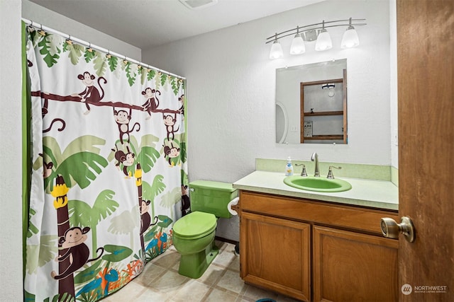 bathroom featuring vanity and toilet