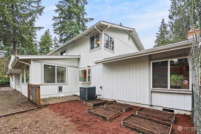 rear view of property with central AC unit