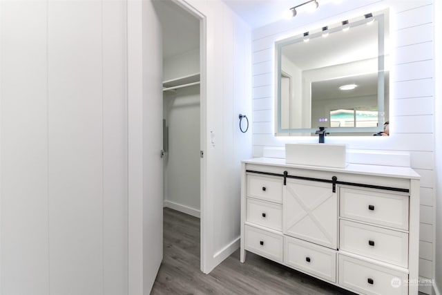 bathroom with vanity, hardwood / wood-style flooring, and wood walls