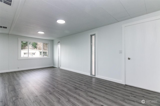 empty room with dark wood-type flooring