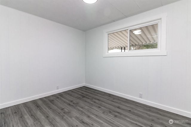 unfurnished room with dark hardwood / wood-style floors