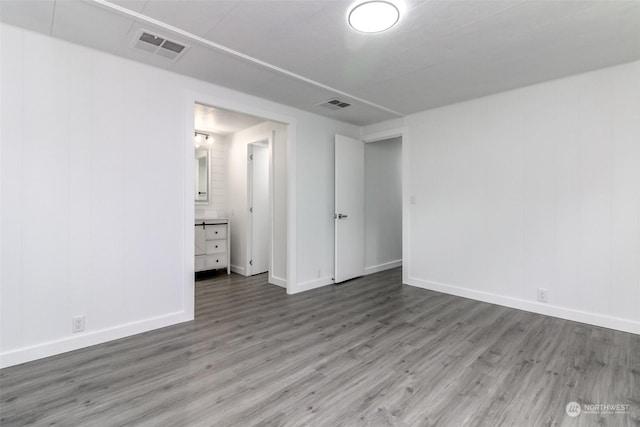 unfurnished room with wood-type flooring