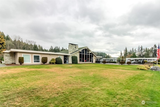 back of property featuring a lawn