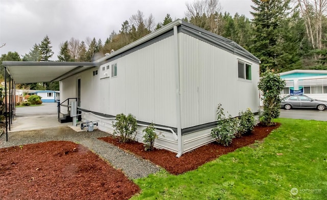 view of side of property with a carport