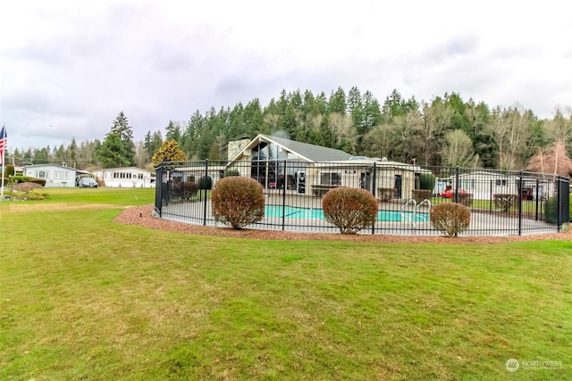 view of pool featuring a lawn