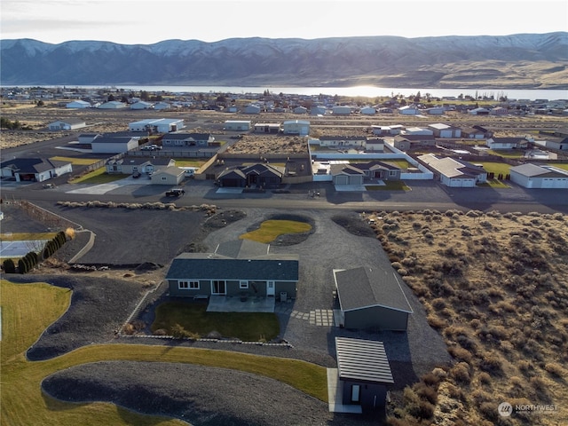 aerial view featuring a water and mountain view