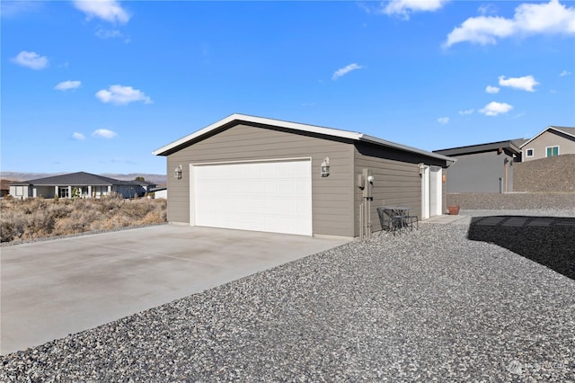 view of home's exterior with a garage and an outdoor structure