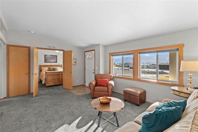 carpeted living room featuring lofted ceiling