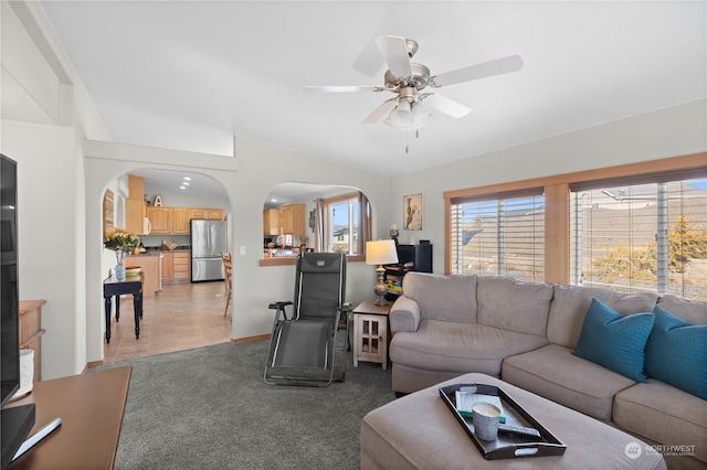 living room with ceiling fan and light colored carpet