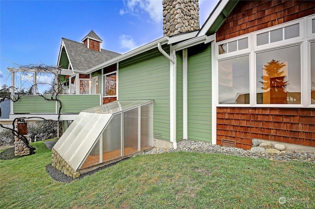 exterior space featuring a lawn and an outdoor structure