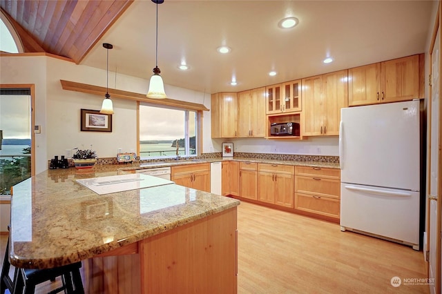 kitchen featuring kitchen peninsula, white fridge, light hardwood / wood-style floors, decorative light fixtures, and light brown cabinetry