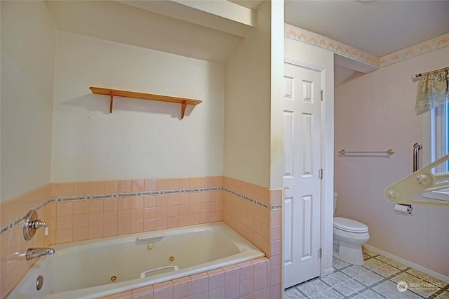 bathroom featuring tile patterned floors, toilet, and tiled bath