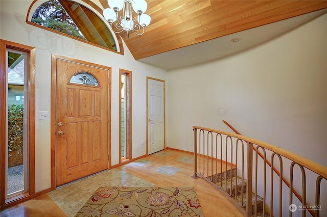 entryway with a notable chandelier, light hardwood / wood-style floors, wooden ceiling, and high vaulted ceiling