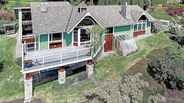 337 Moana Dr, Camano Island, WA 98282 - back of property featuring a greenhouse, a shingled roof, a chimney, a deck, and a yard