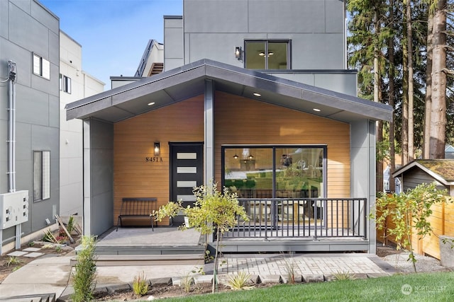 back of property featuring covered porch