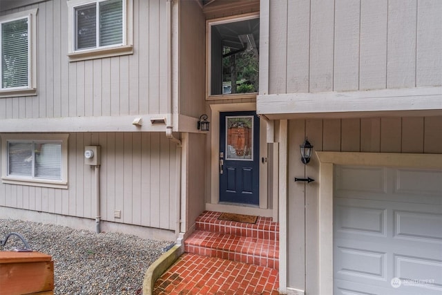 doorway to property with a garage