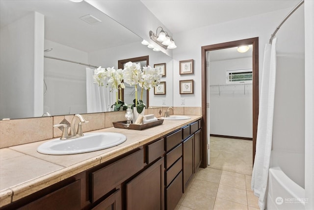 bathroom featuring tile patterned flooring, vanity, and shower / tub combo with curtain