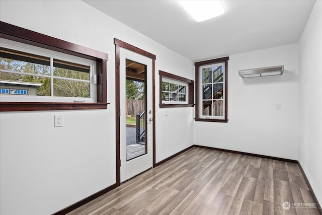 interior space with a wealth of natural light and light hardwood / wood-style flooring