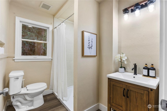 full bathroom with ornamental molding, vanity, shower / bath combo with shower curtain, hardwood / wood-style flooring, and toilet