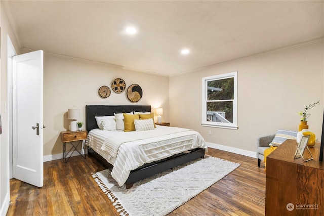 bedroom with dark hardwood / wood-style floors and crown molding