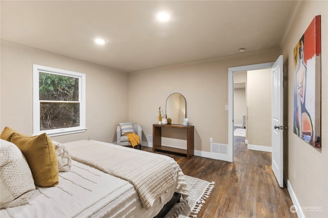 bedroom featuring dark hardwood / wood-style floors and crown molding