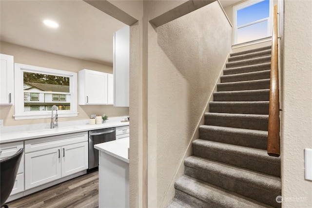 stairway with hardwood / wood-style flooring and sink