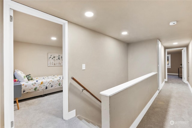 hallway with light colored carpet