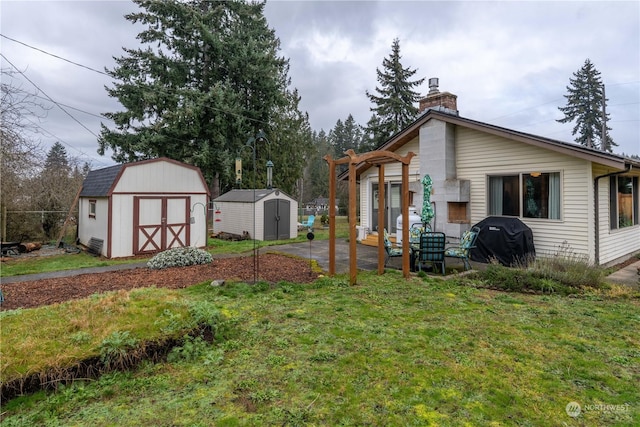 view of yard featuring a pergola and a shed