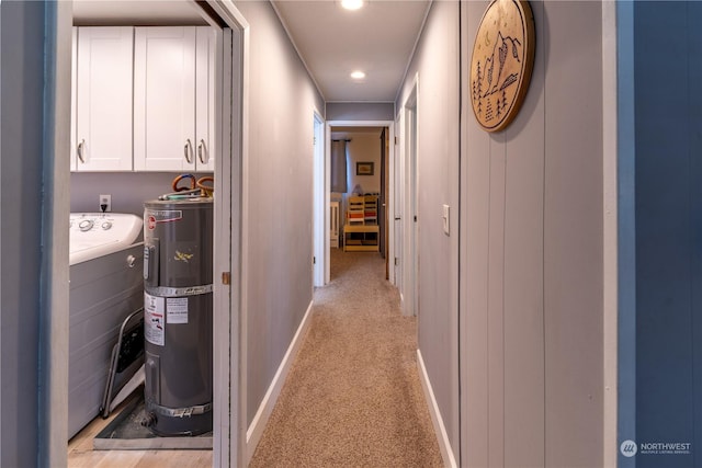 hall with electric water heater and light colored carpet