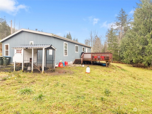 back of property featuring a yard and a wooden deck