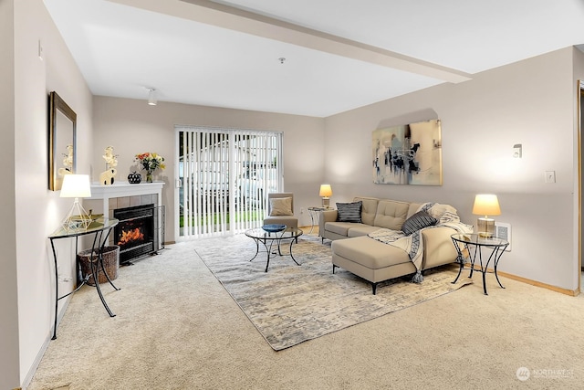 carpeted living room with a tiled fireplace