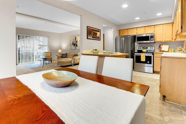 kitchen with appliances with stainless steel finishes, light brown cabinets, and sink