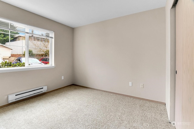 empty room with carpet and a baseboard heating unit