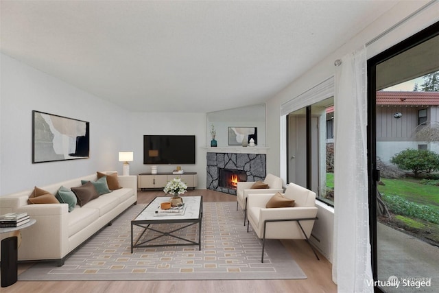 living room with a fireplace and light hardwood / wood-style floors