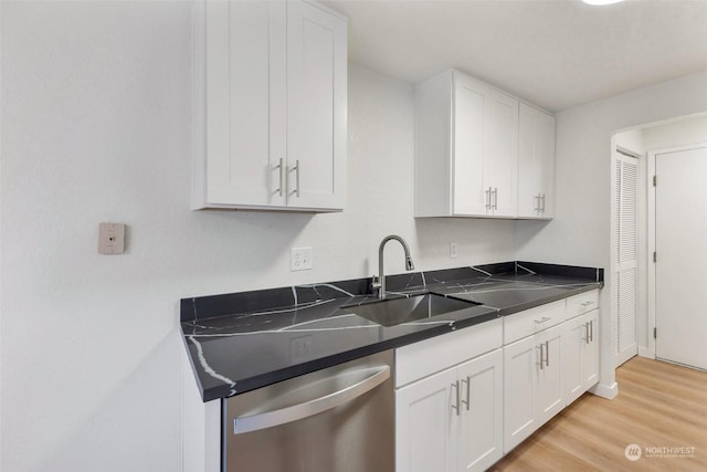 kitchen featuring white cabinetry, dishwasher, light wood-type flooring, and sink