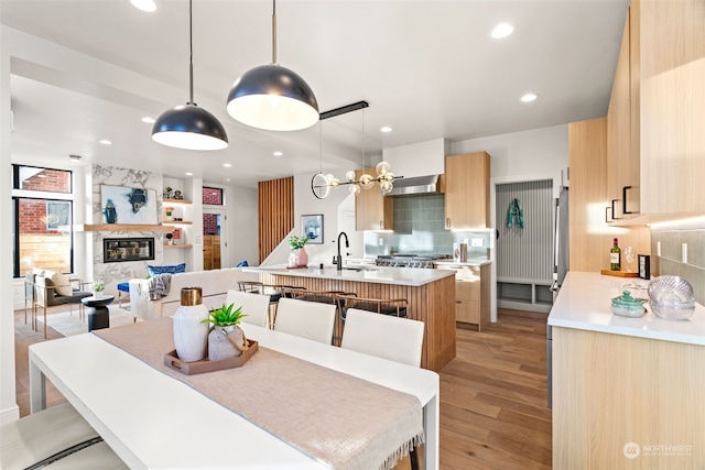 dining space with light wood-type flooring and sink