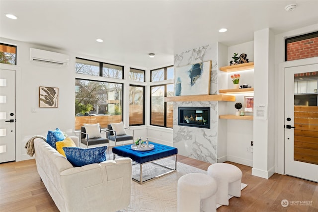 5537 34th Ave NE, Seattle, WA 98105 - living room with light hardwood / wood-style floors, an AC wall unit, and a healthy amount of sunlight
