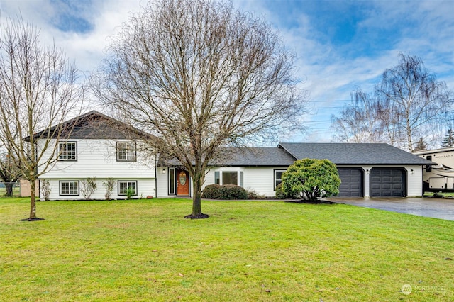 tri-level home with a garage and a front lawn