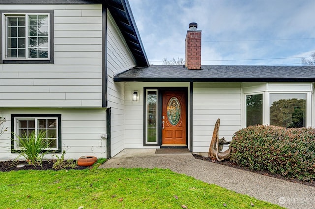 property entrance with a yard