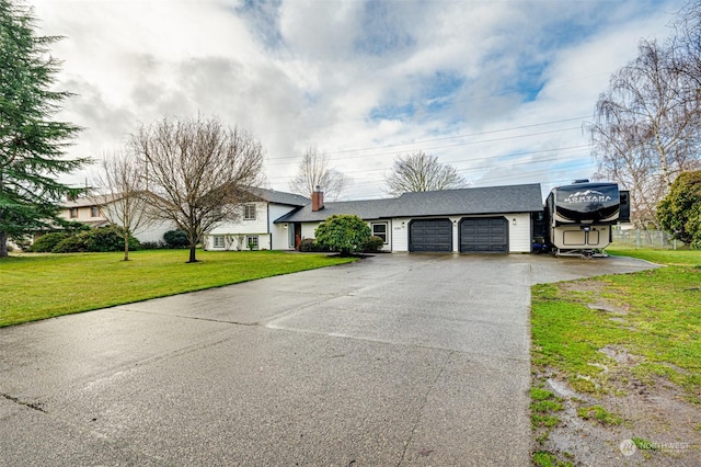 single story home featuring a front yard and a garage