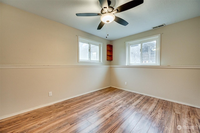 empty room featuring light wood-type flooring and ceiling fan