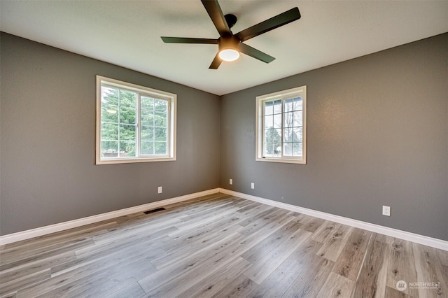 spare room featuring light hardwood / wood-style flooring and ceiling fan