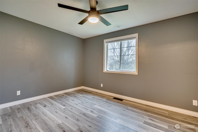 spare room with ceiling fan and light hardwood / wood-style floors