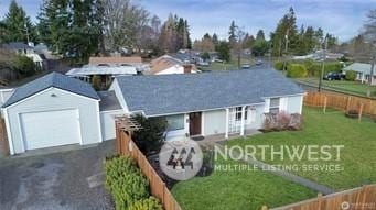 single story home featuring a garage and a front yard