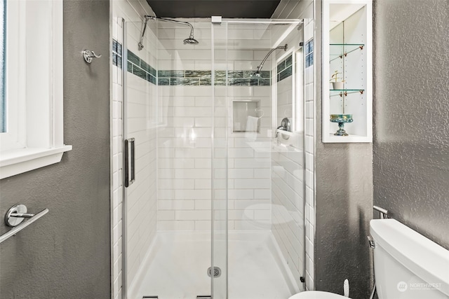 bathroom featuring toilet and walk in shower