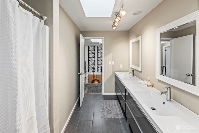 bathroom featuring vanity and a skylight