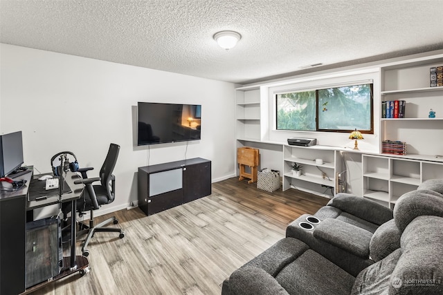 office space featuring a textured ceiling and hardwood / wood-style flooring