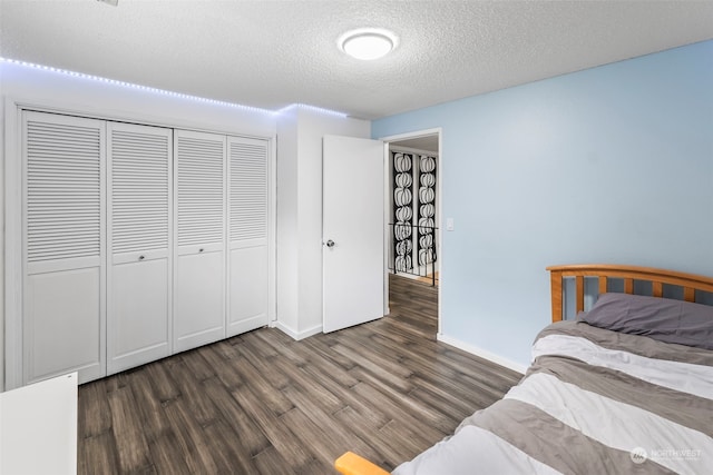 unfurnished bedroom with a closet, dark hardwood / wood-style floors, and a textured ceiling