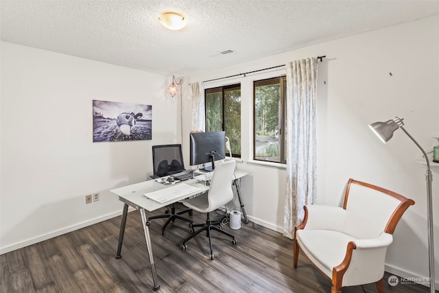 home office with dark hardwood / wood-style flooring and a textured ceiling