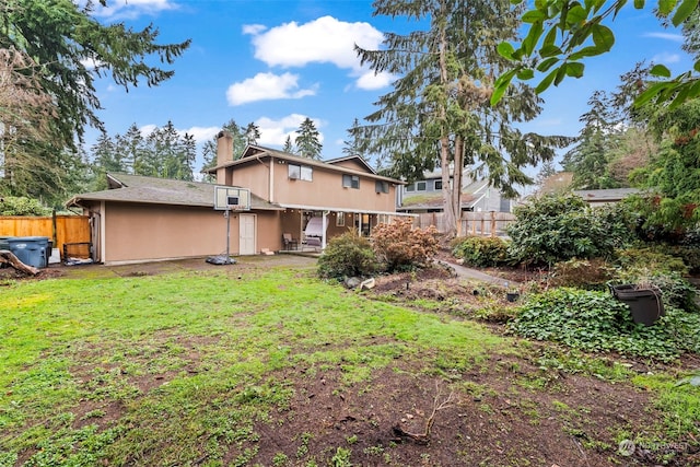 rear view of property featuring a lawn